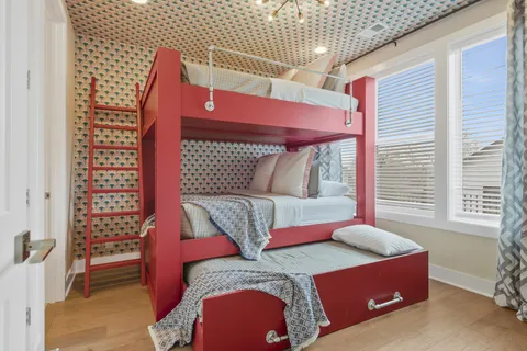 a bed sitting in a bedroom next to a window