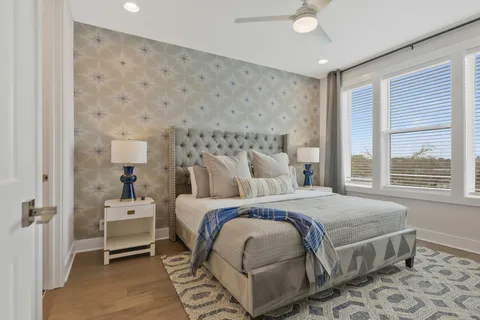 a bed room with a bed a television and a window