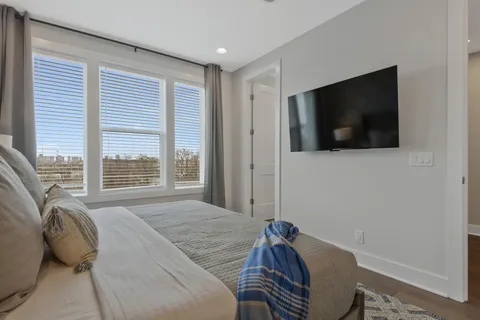 a bedroom with a bed and a flat screen tv