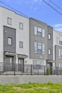 a front view of a building with a garden