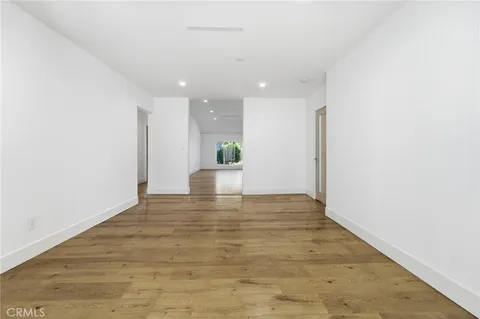 a view of an empty room and wooden floor
