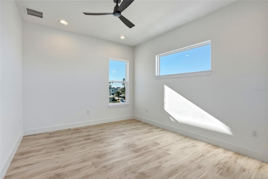 534 Crystal Drive Madeira Beach, FL 33708 - Photo 42 of 68 an empty room with wooden floor and windows