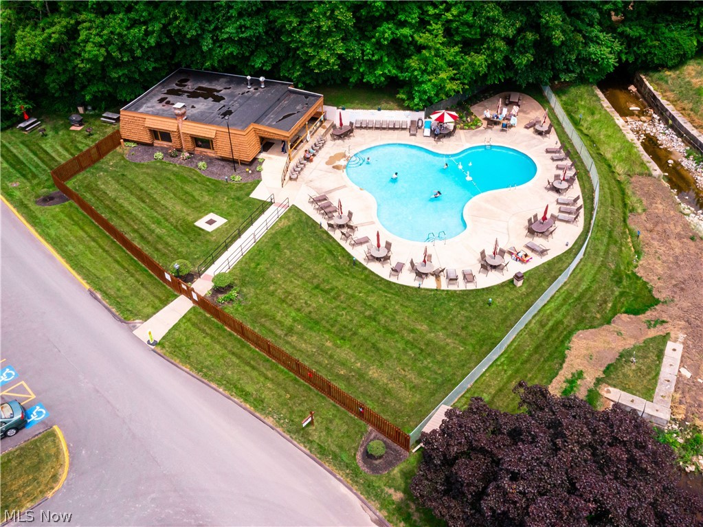 3064 Kent Road Stow, OH 44224 - Photo 3 of 30 Kidney-shaped swimming pool with an expansive concrete sundeck, surrounded by manicured lawns and mature trees