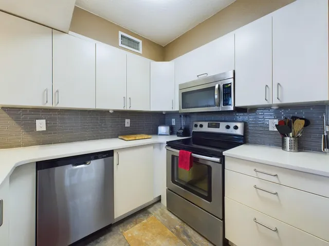 a kitchen with a stove and a microwave