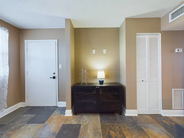 a room with a bed and a dresser