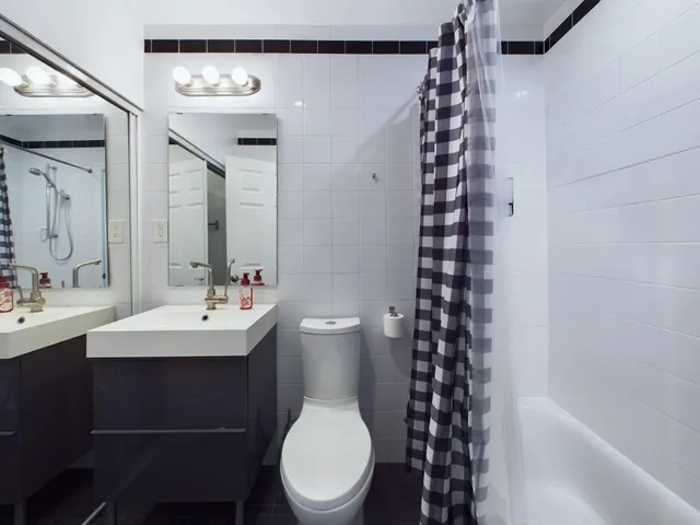 a bathroom with a toilet a sink and a mirror