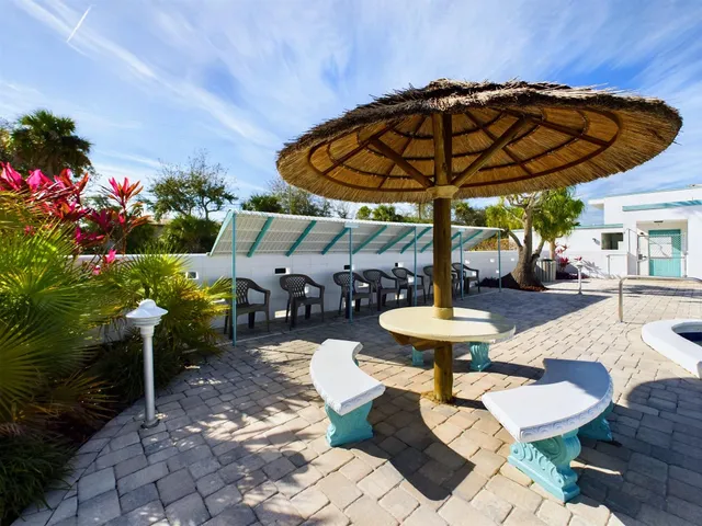 a view of a chairs and table in backyard