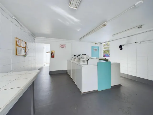 a view of a kitchen with furniture and wooden floor