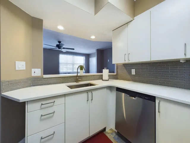 a kitchen with a sink and cabinets