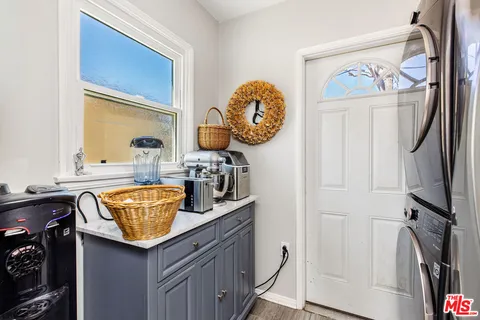 a room with granite countertop a sink and a wooden floor