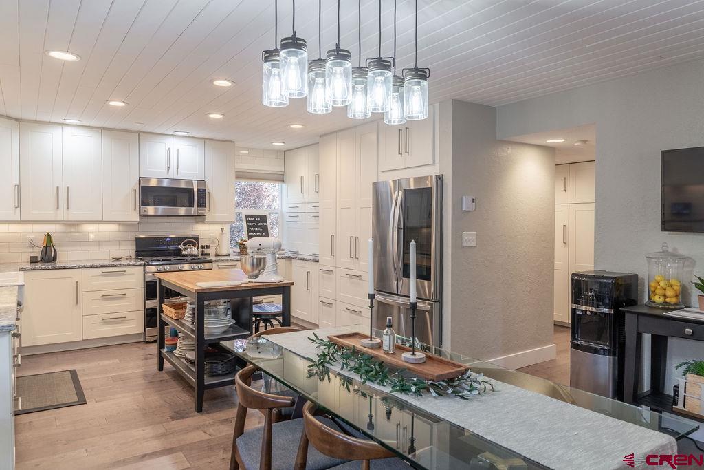 269 Fir Drive Durango, CO 81301 - Photo 4 of 23 a kitchen with kitchen island granite countertop stainless steel appliances cabinets a sink and a island