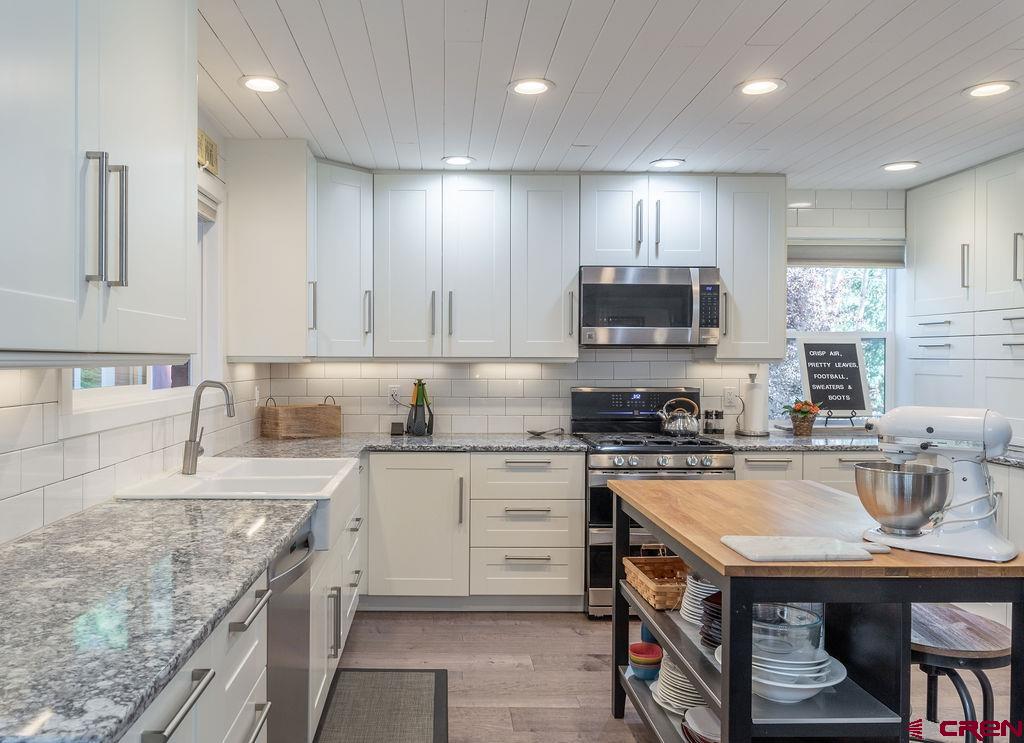 269 Fir Drive Durango, CO 81301 - Photo 5 of 23 a kitchen that has a lot of cabinets in it wooden floor and appliances