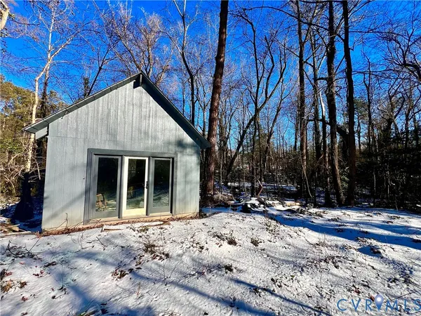 a view of a house with a snow in the yard
