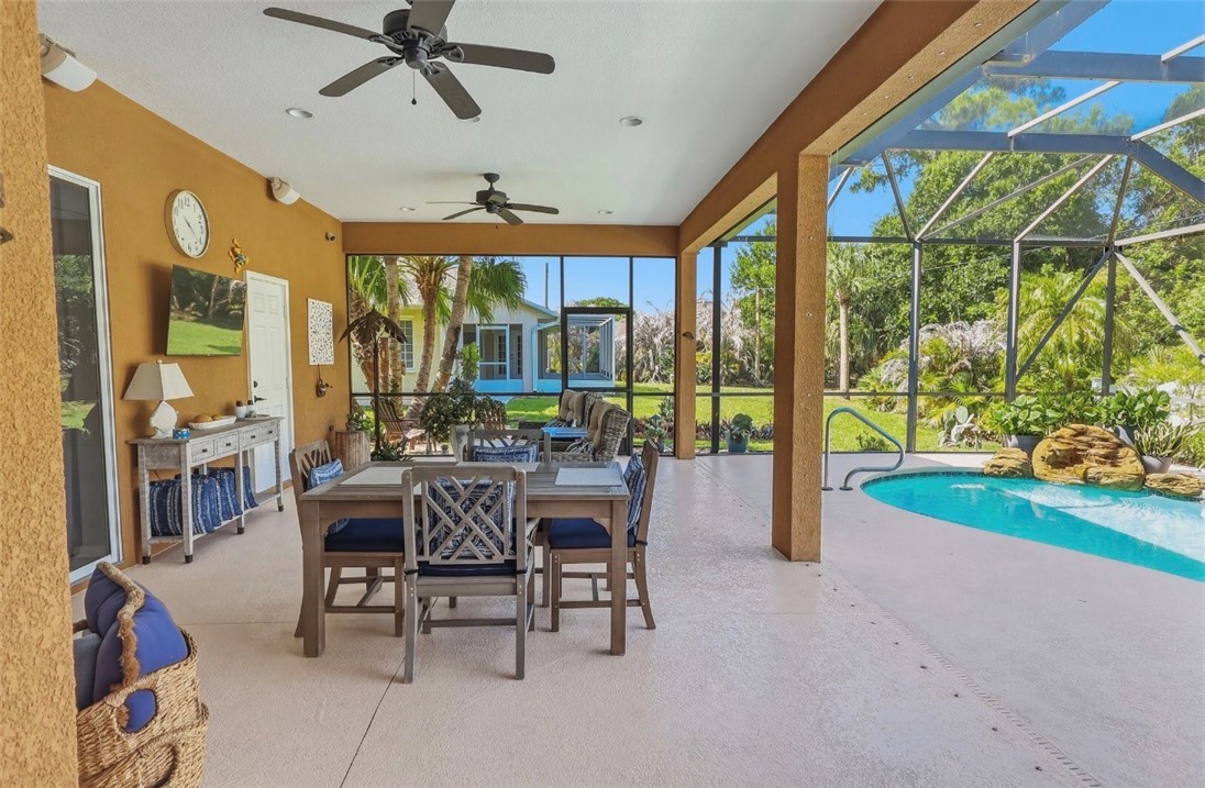 1771 Mistletoe Street Sebastian, FL 32958 - Photo 27 of 36 a dining room with furniture water view and a floor to ceiling window