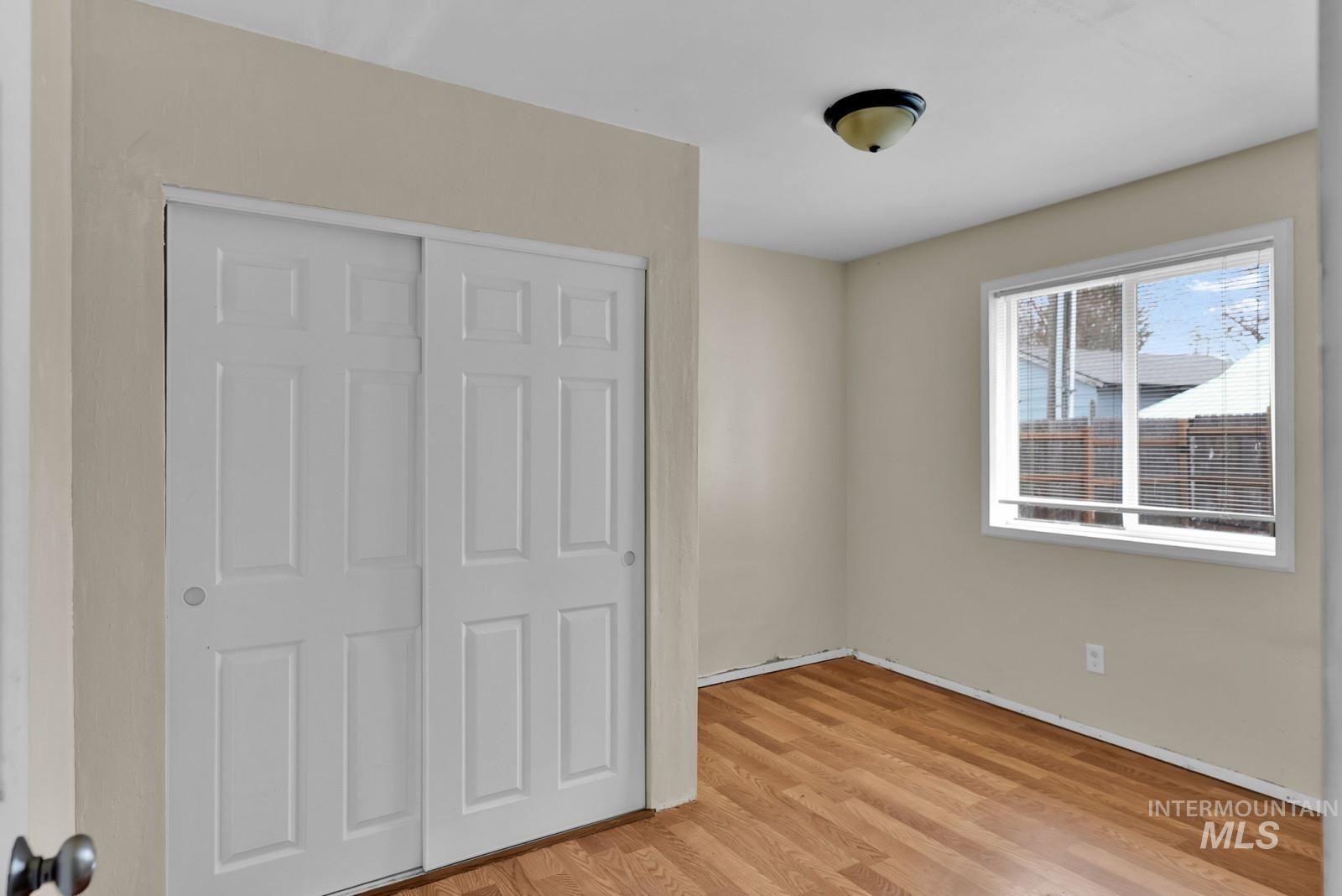 4715 West Reeves Street Coeur D'Alene, ID 83814 - Photo 12 of 24 Unfurnished bedroom featuring light wood-style floors and a closet