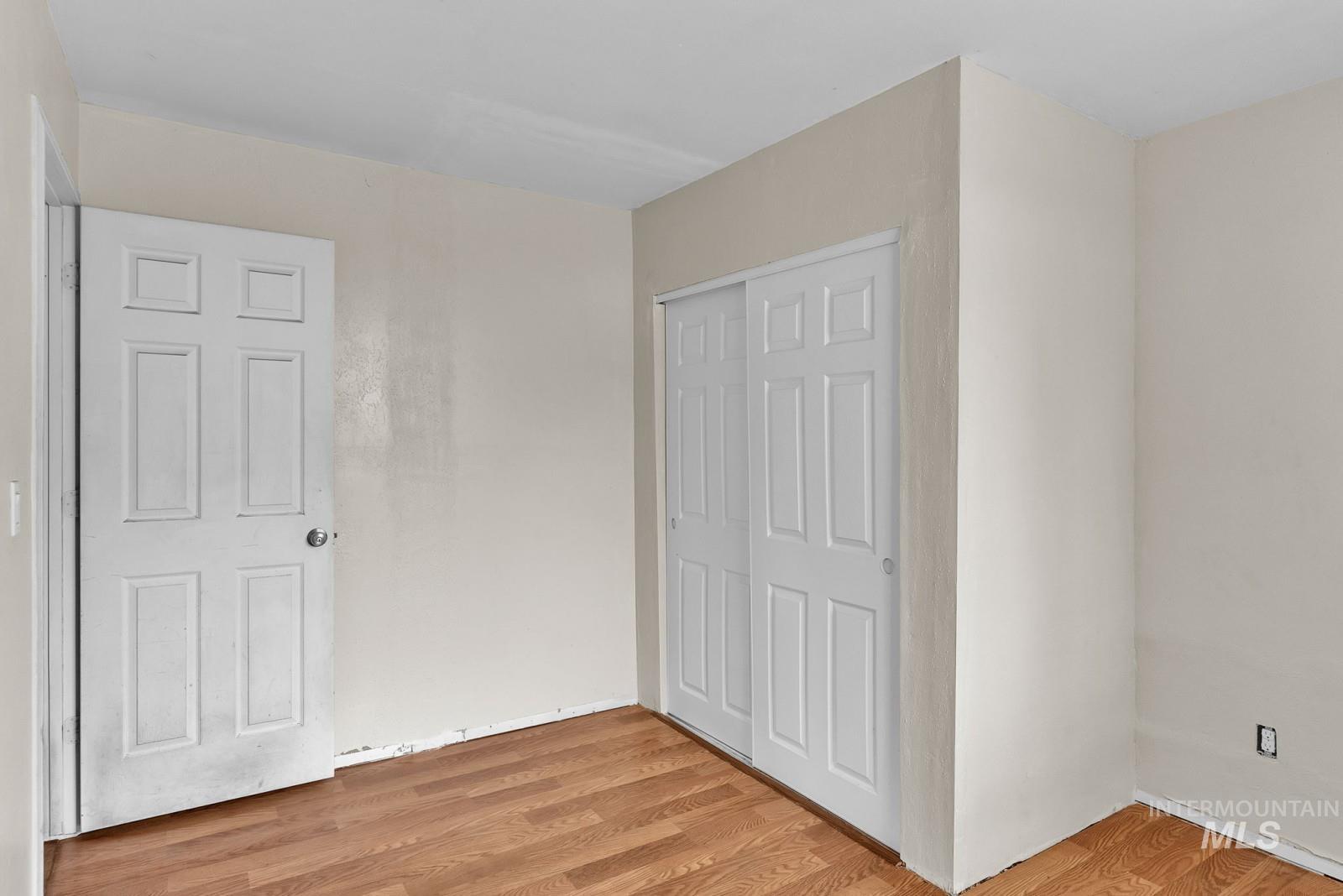 4715 West Reeves Street Coeur D'Alene, ID 83814 - Photo 13 of 24 Unfurnished bedroom featuring light wood-style floors and a closet