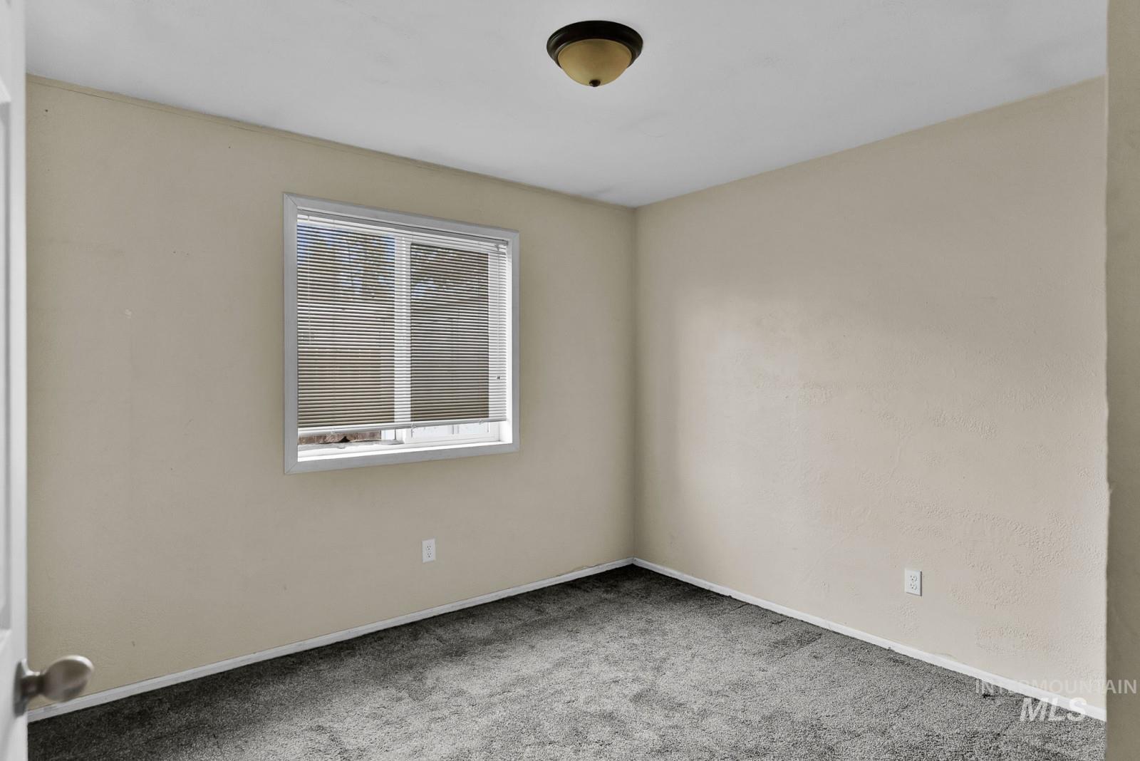 4715 West Reeves Street Coeur D'Alene, ID 83814 - Photo 14 of 24 Carpeted spare room featuring baseboards