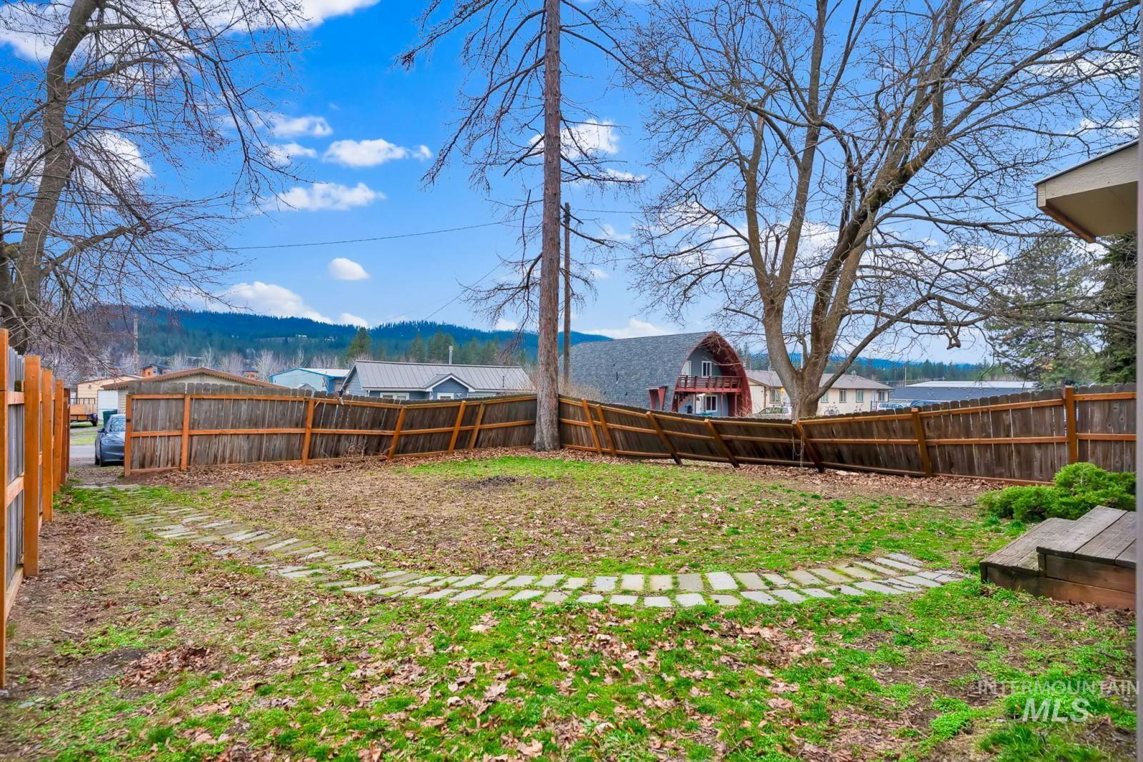 4715 West Reeves Street Coeur D'Alene, ID 83814 - Photo 18 of 24 Fenced backyard with a mountain view
