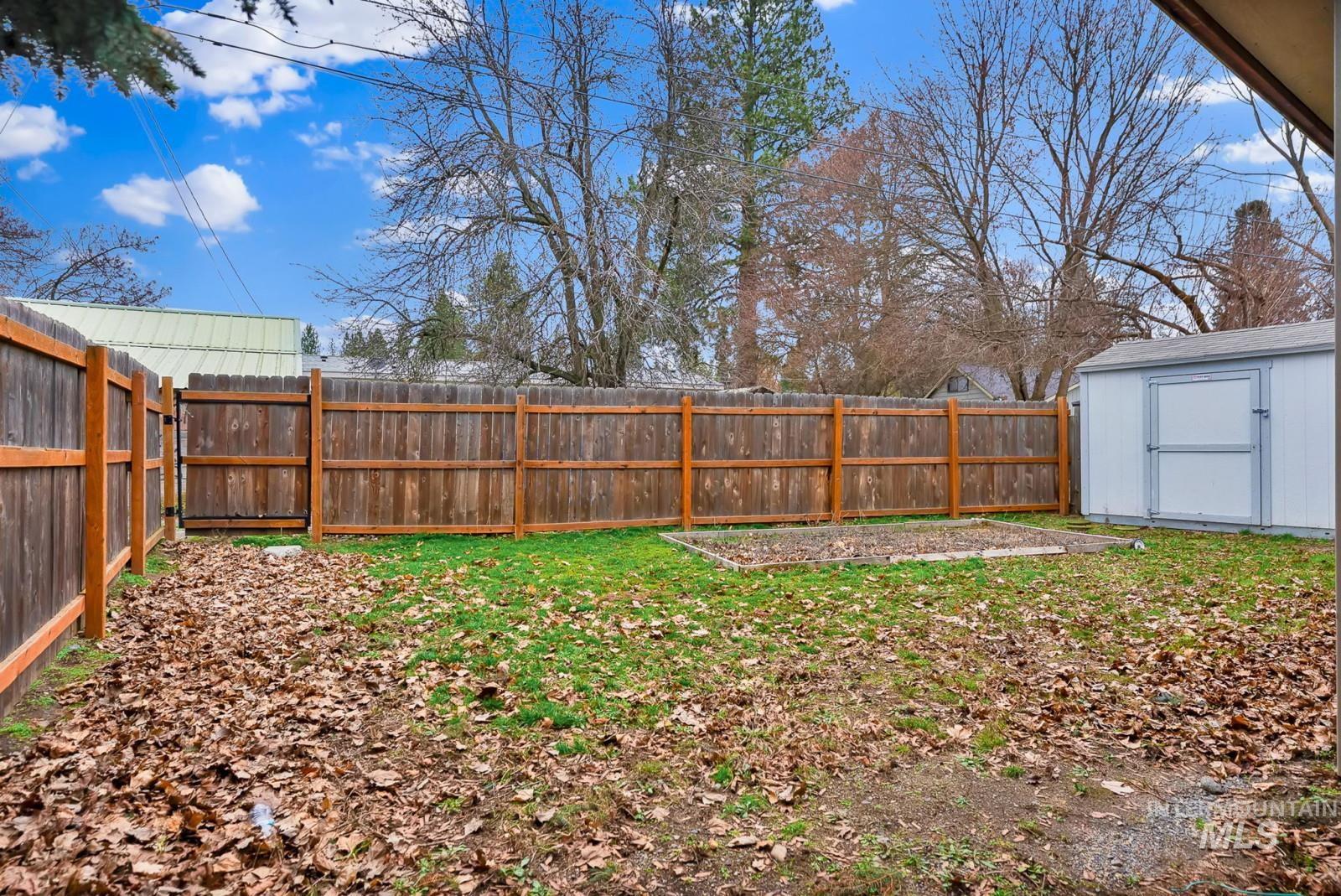 4715 West Reeves Street Coeur D'Alene, ID 83814 - Photo 21 of 24 Fenced backyard featuring a shed