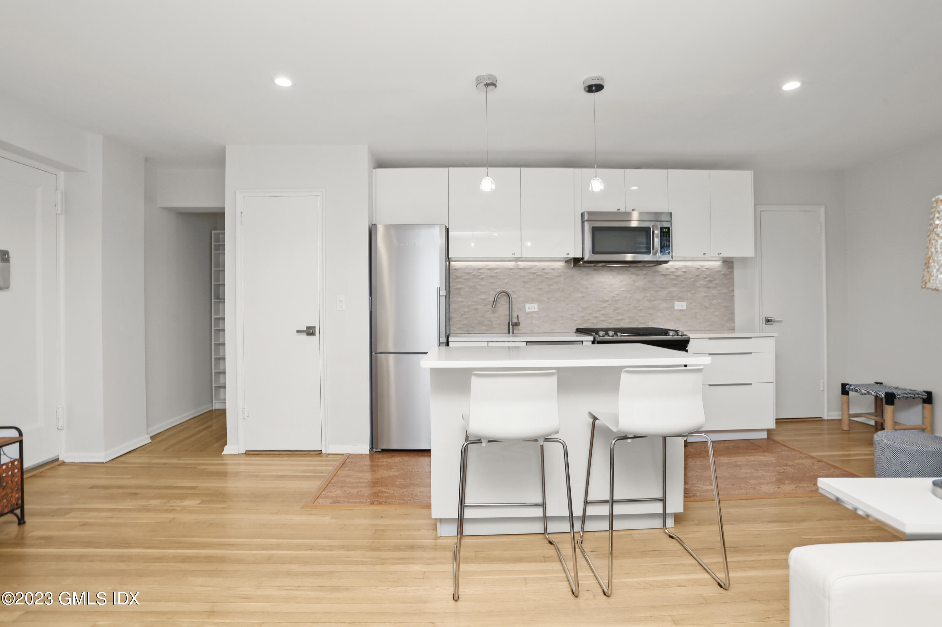 52 Lafayette Place, Unit 1F Greenwich, CT 06830 - Photo 2 of 10 a kitchen with a sink cabinets and wooden floor