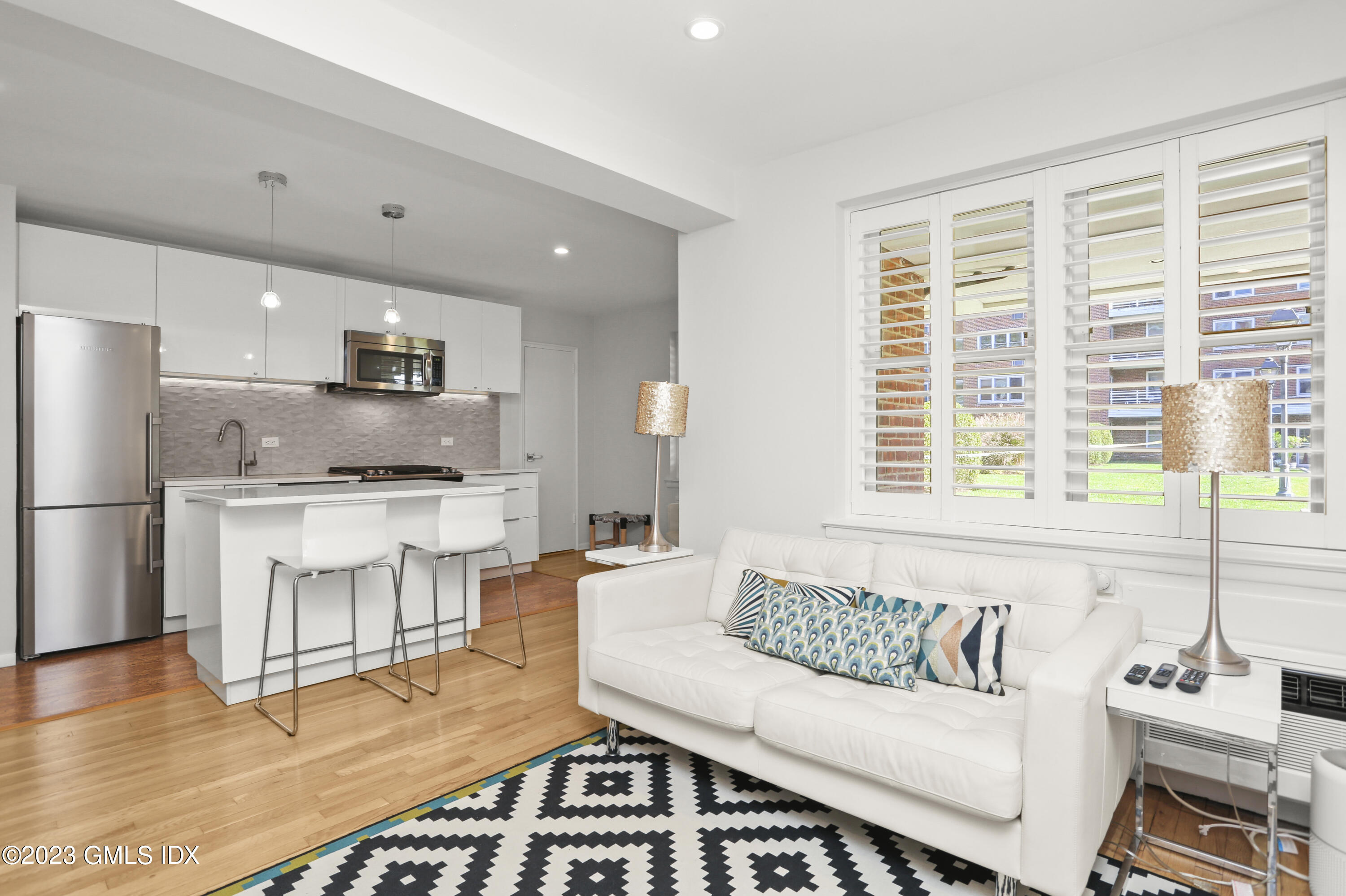 52 Lafayette Place, Unit 1F Greenwich, CT 06830 - Photo 3 of 10 a living room with furniture and a large window