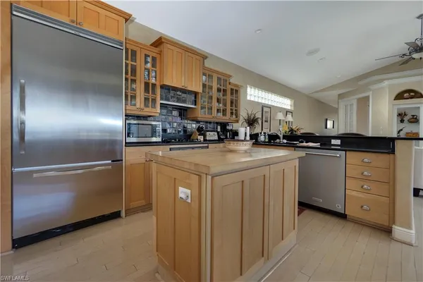 a kitchen with stainless steel appliances a sink stove and refrigerator