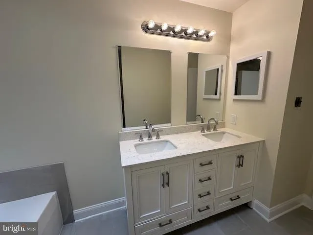 a bathroom with a double vanity sink and a mirror