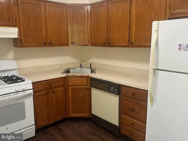 a kitchen with a sink a stove and cabinets