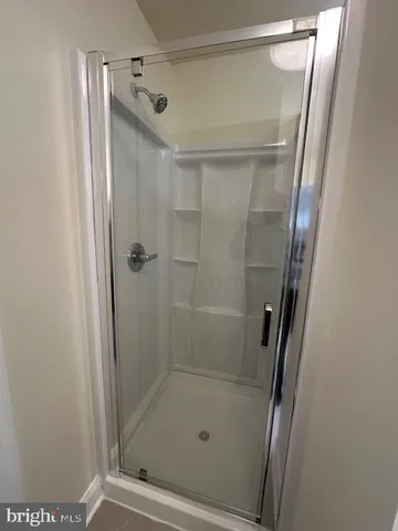 a bathroom with a glass door shower