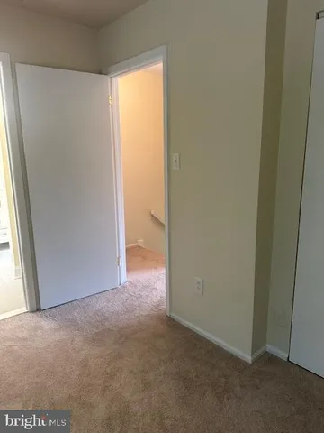 a view of an empty room and a window