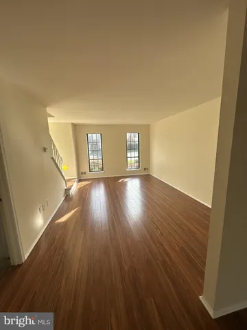 a view of a room with wooden floors