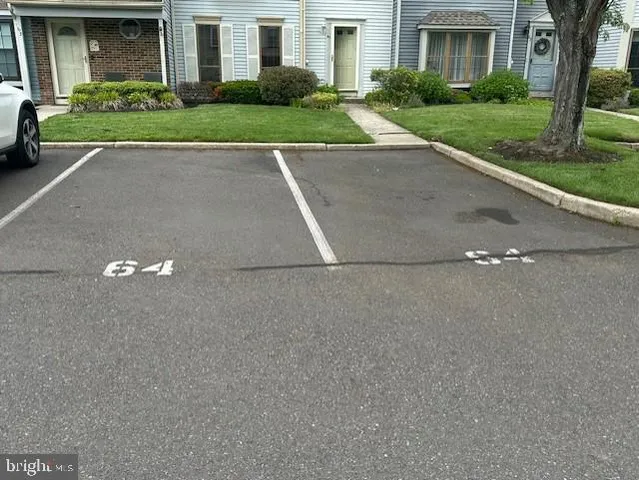 a view of a house with a yard and a garage