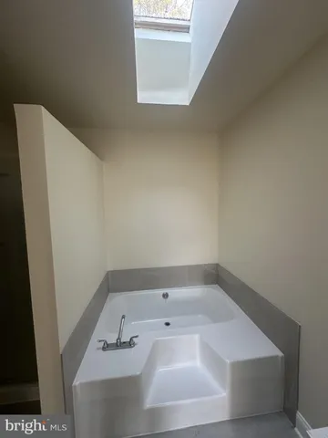 a bathroom with a bathtub and a toilet