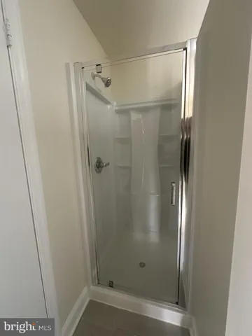 a white toilet sitting next to a white cabinet