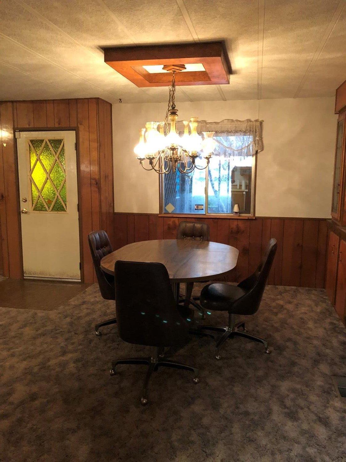 6226 East Evans Creek Road, Unit 15 Rogue River, OR 97537 - Photo 16 of 30 a dining room with furniture and chandelier