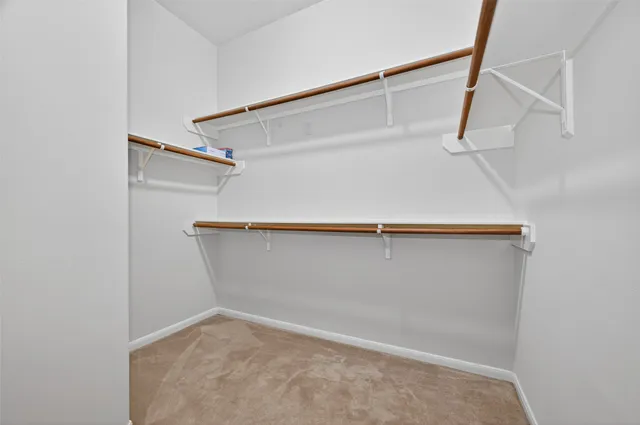 an empty room with a chandelier fan