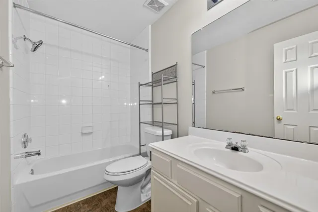 an empty room with a chandelier fan and closet area