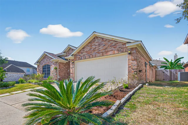 a view of a house with a small yard and plants