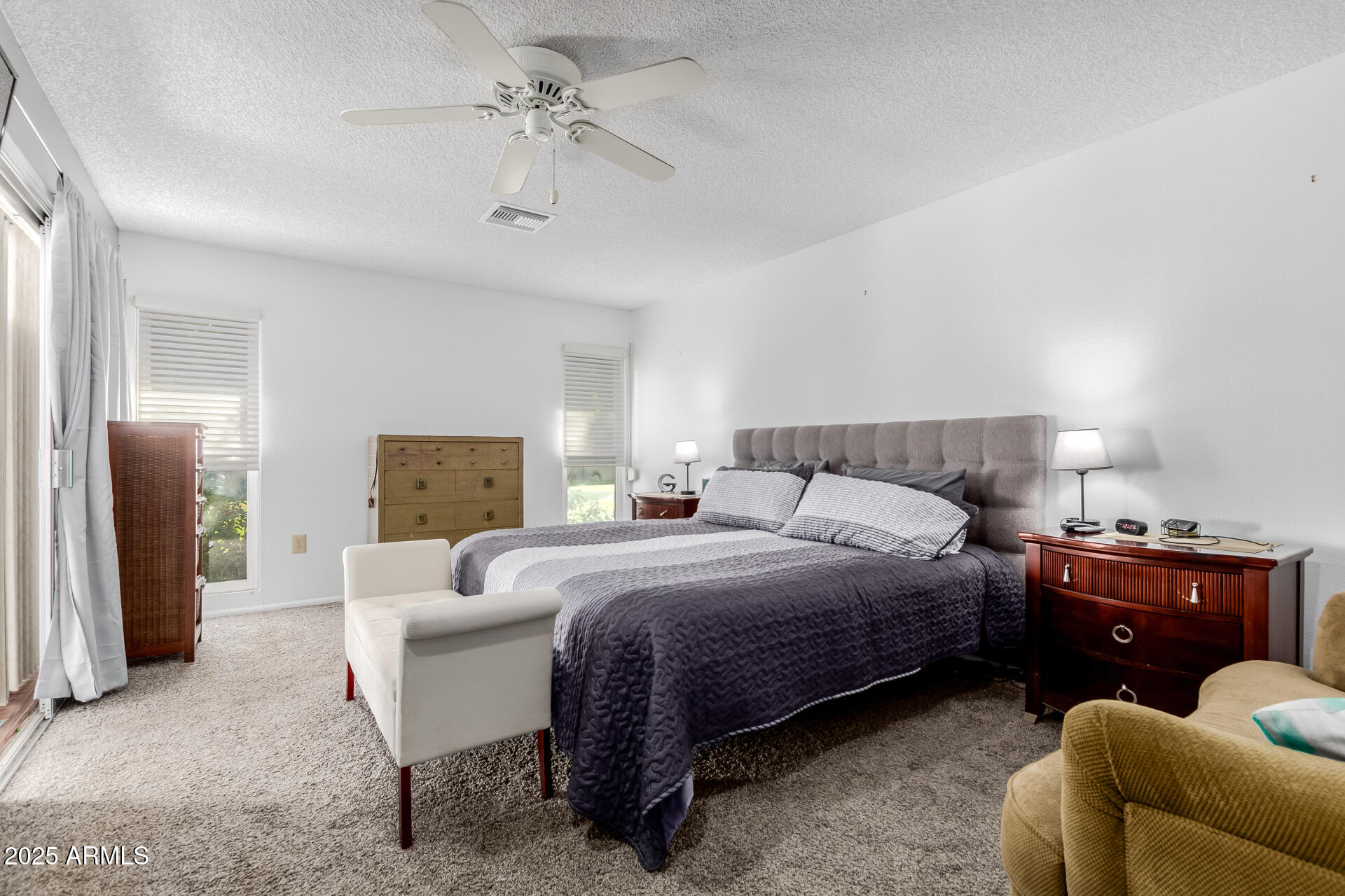10023 West Pleasant Valley Road Sun City, AZ 85351 - Photo 12 of 41 a bedroom with a bed and a chandelier