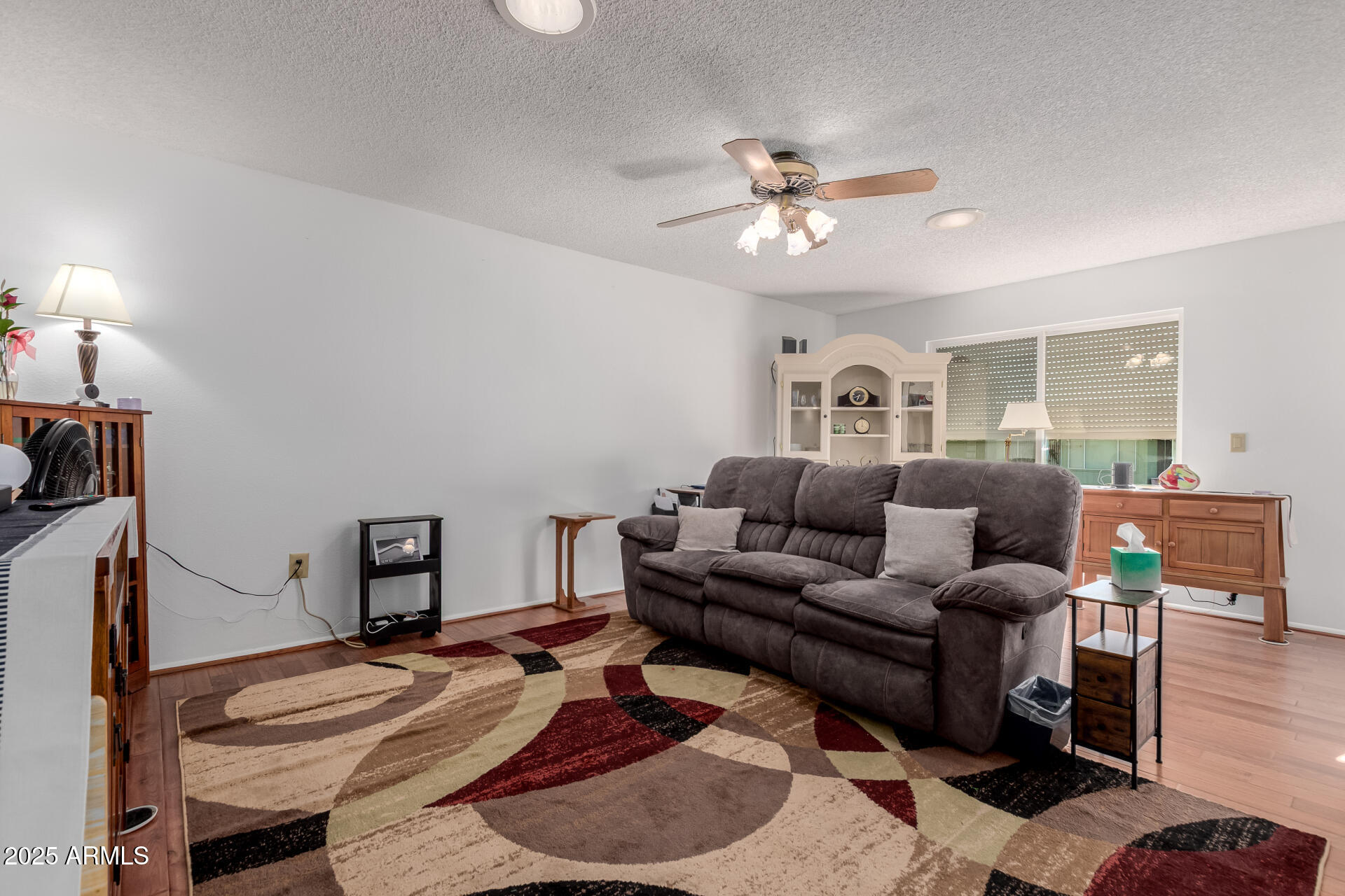 10023 West Pleasant Valley Road Sun City, AZ 85351 - Photo 8 of 41 a living room with furniture a ceiling fan and a rug