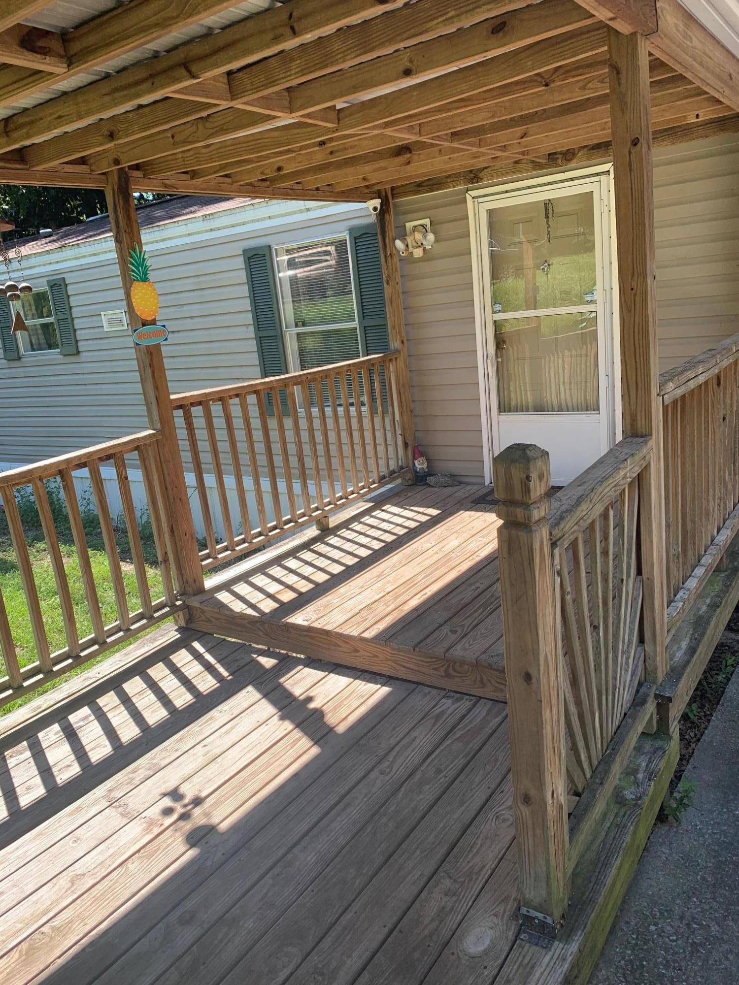 725 Squirrel Road DeFuniak Springs, FL 32433 - Photo 1 of 14 a view of a balcony with wooden floor