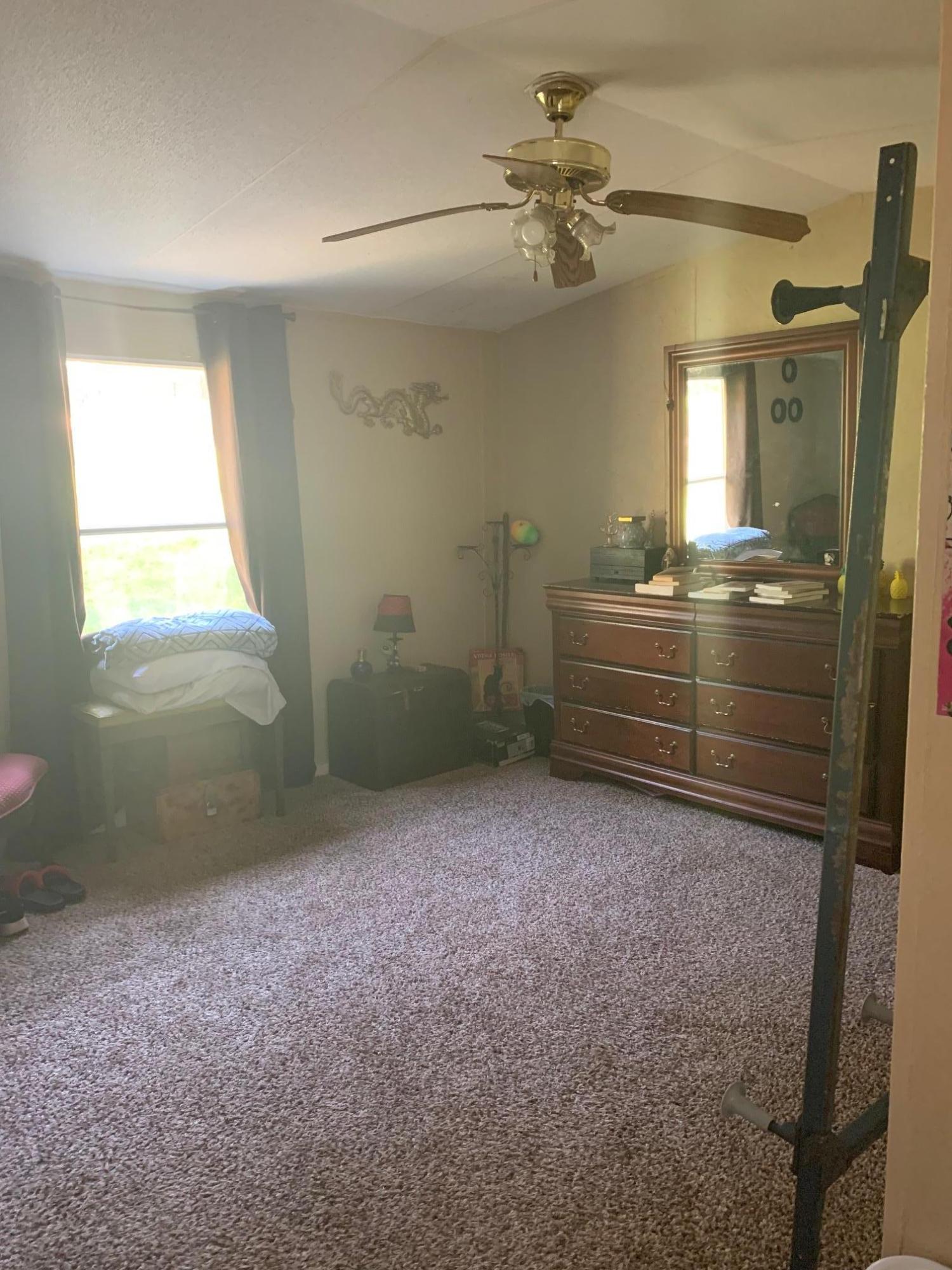 725 Squirrel Road DeFuniak Springs, FL 32433 - Photo 9 of 14 a view of room with a ceiling fan and window