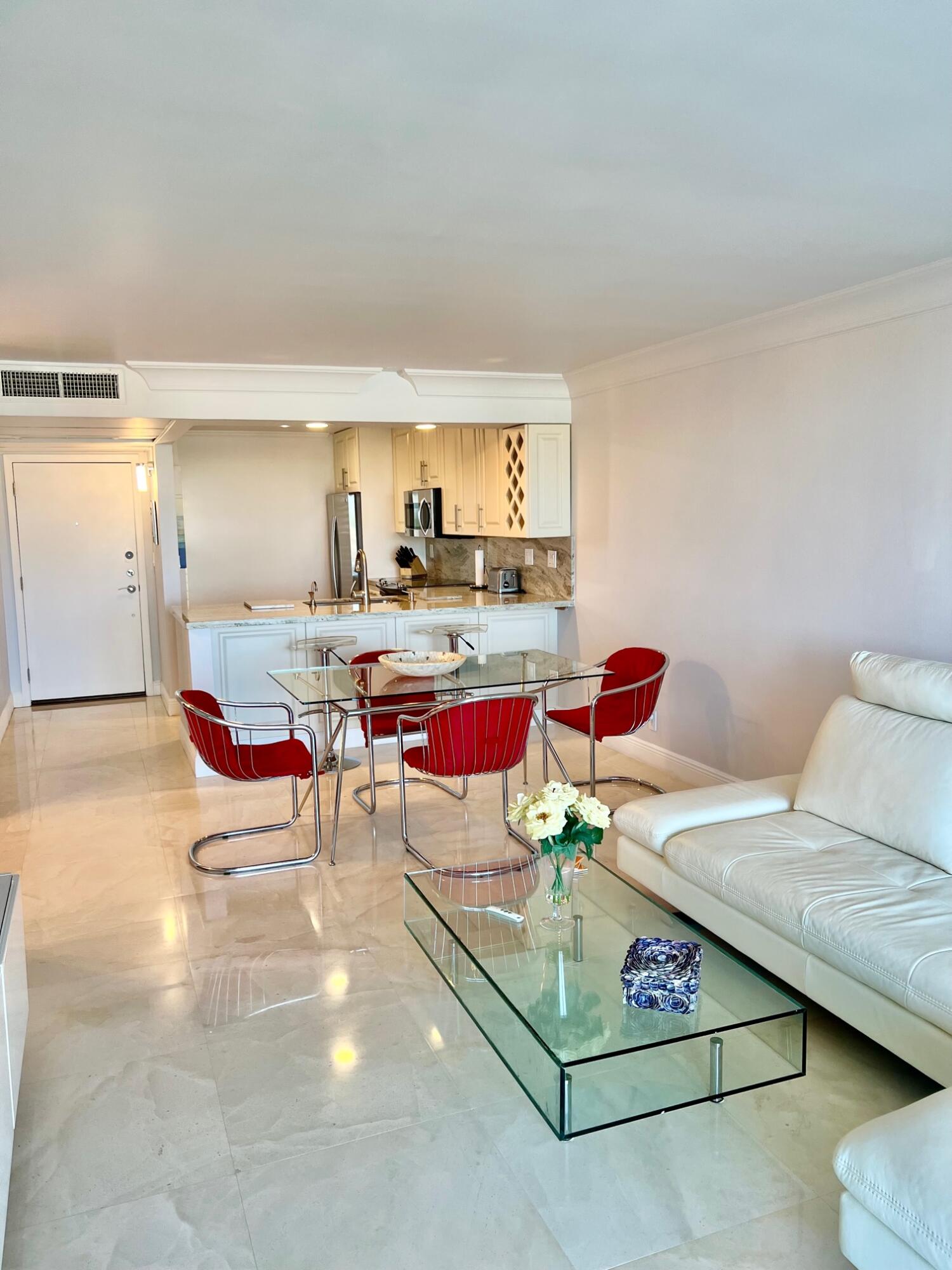 6 Royal Palm Way, Unit 607 Boca Raton, FL 33432 - Photo 4 of 16 a living room with furniture and a table