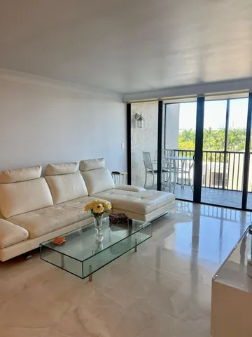 a bedroom with furniture and a large window