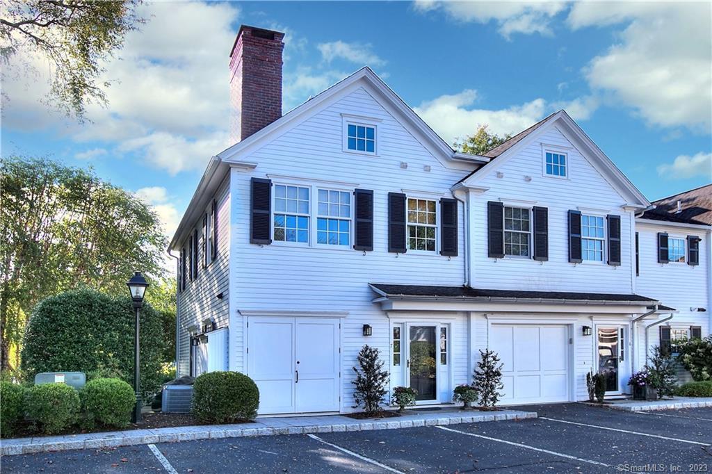 220 Riverside Avenue, Unit 7 Westport, CT 06880 - Photo 1 of 1 a front view of a house with a yard