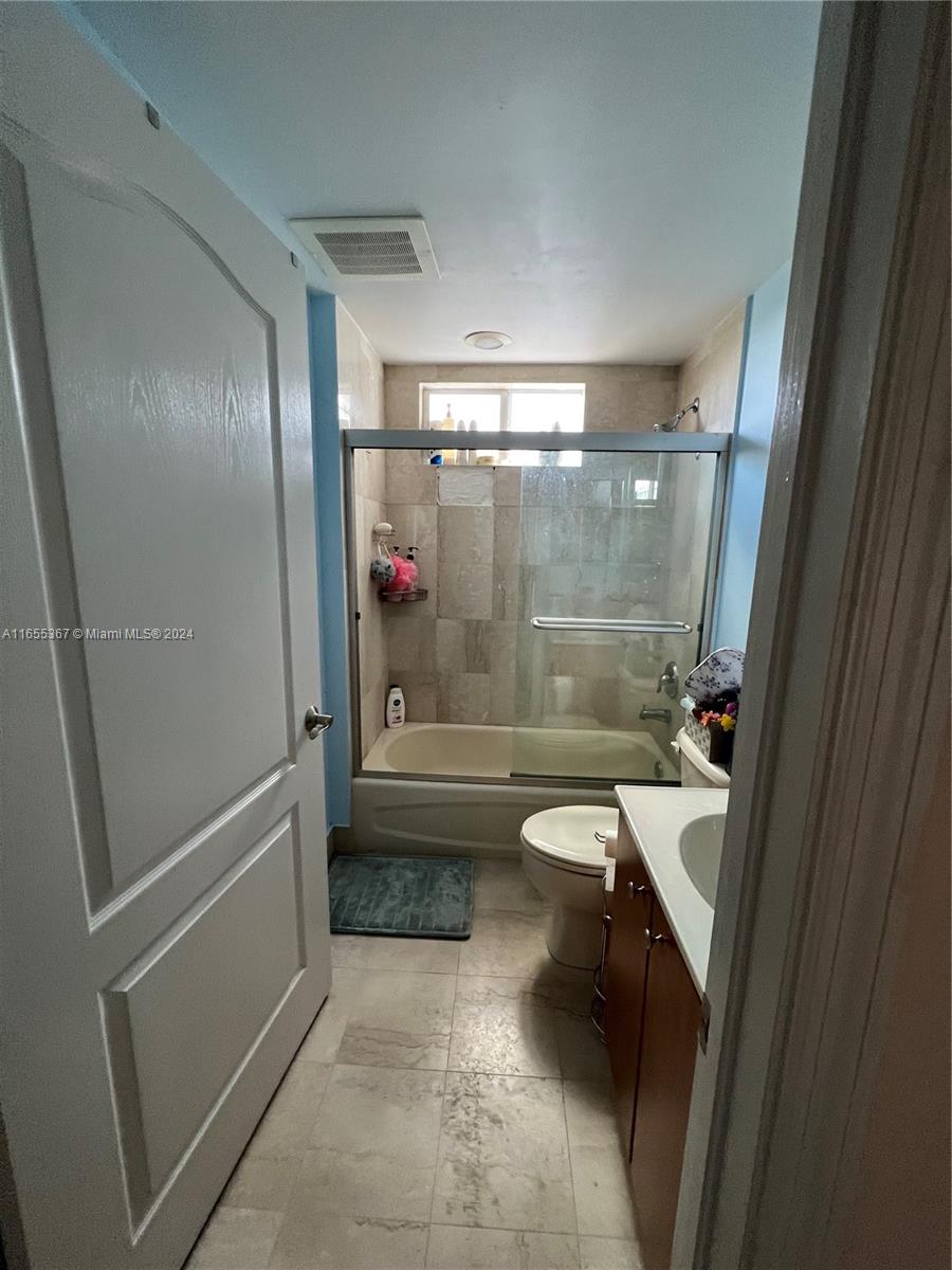 2550 Southwest 27th Avenue, Unit 703 Miami, FL 33133 - Photo 12 of 18 a bathroom with a shower and a toilet