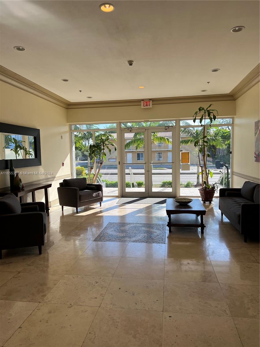 2550 Southwest 27th Avenue, Unit 703 Miami, FL 33133 - Photo 4 of 18 a living room with furniture and a large window