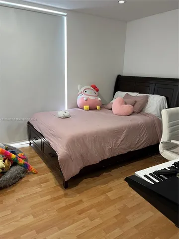 a bedroom with a bed and a desk