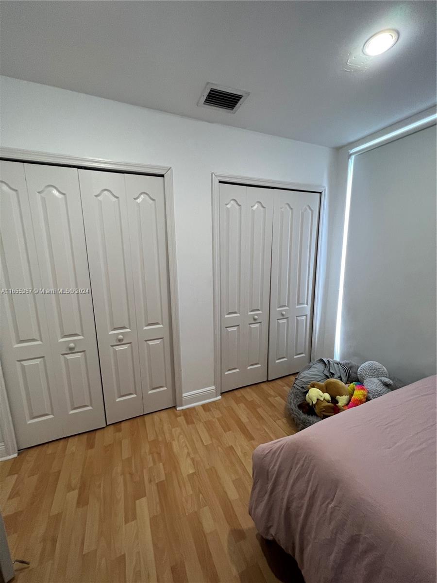 2550 Southwest 27th Avenue, Unit 703 Miami, FL 33133 - Photo 10 of 18 a bedroom with a bed and a shower