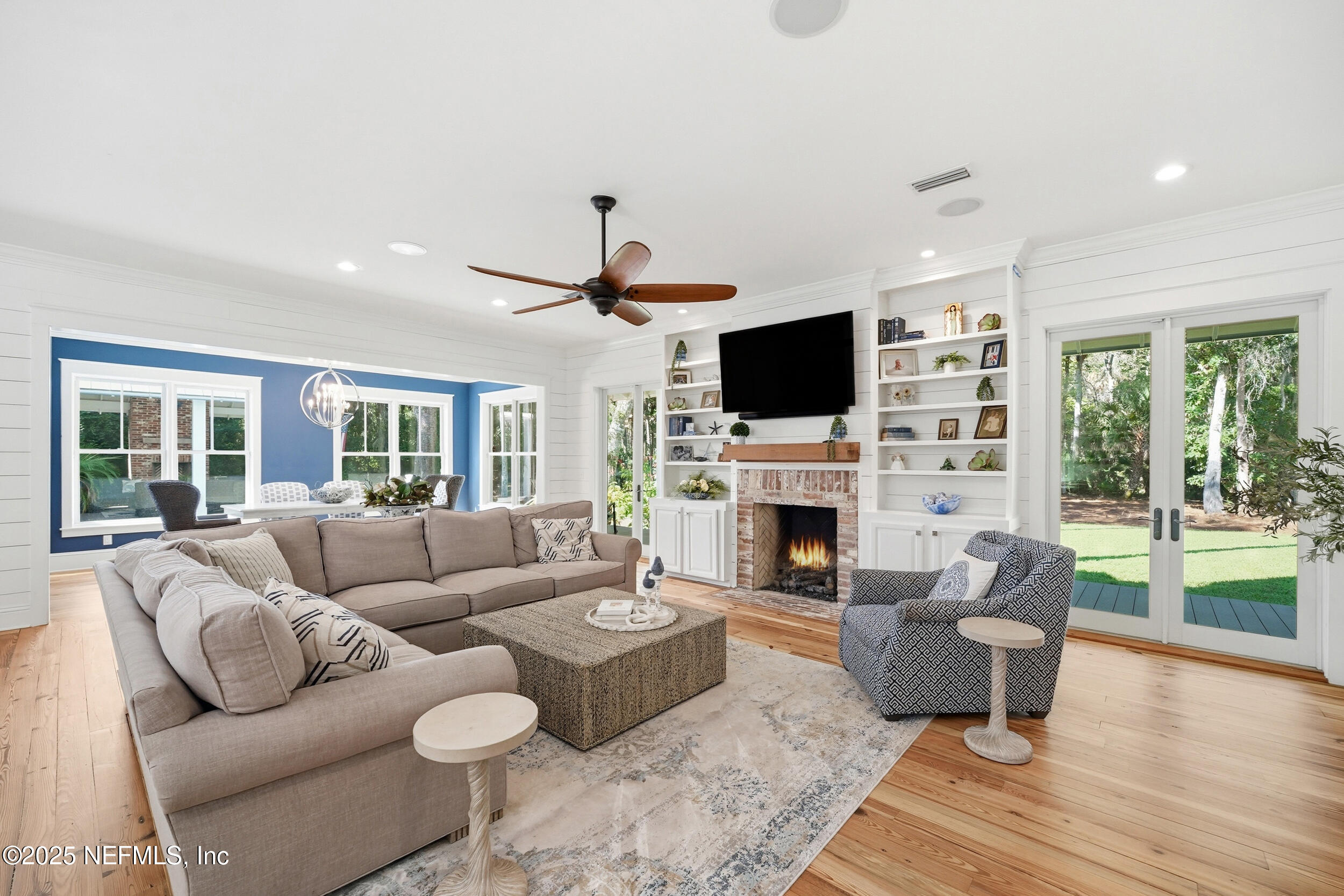 4745 Palm Valley Road Ponte Vedra Beach, FL 32082 - Photo 23 of 104 a living room with furniture a fireplace and a flat screen tv